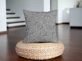 Almohada de salud gris con hojas de palma blancas