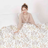 Set de ropa de cama con mantas terapéuticas y delicadas ramas coloridas