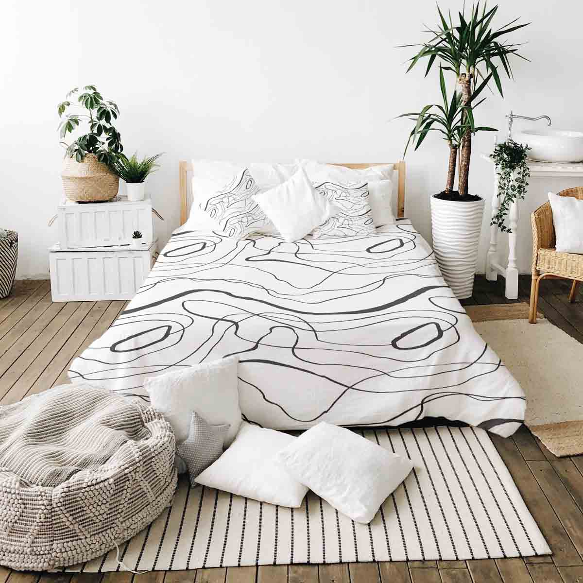 Set de ropa de cama con mantas terapéuticas y líneas serpenteantes negras