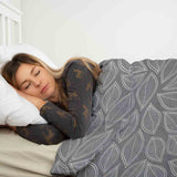 Juego de ropa de cama con manta terapéutica gris con hojas de palma blancas