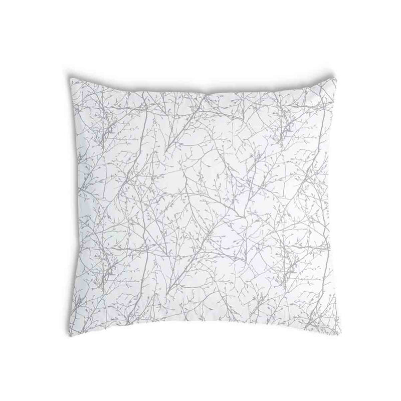 Almohada de salud blanca con delicadas ramas grises