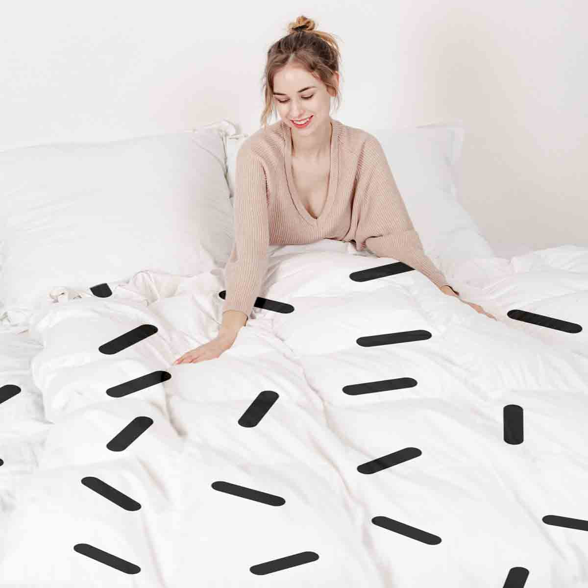 Set de ropa de cama con mantas terapéuticas y rayas negras