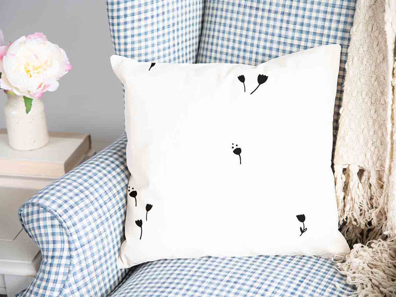 Almohada de salud blanca con dientes de león negros