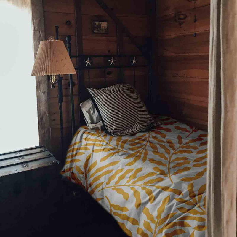 Set de ropa de cama con mantas terapéuticas y ramas amarillas